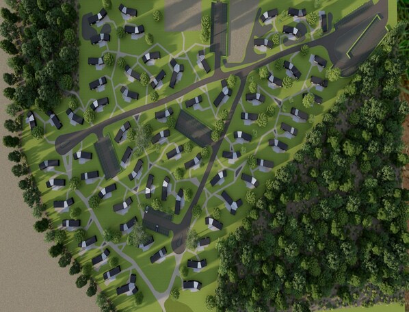 An aerial view of a residential area with multiple houses, roads, and green spaces. - Palette Resort De-steppe Family Stay (Ulicoten)