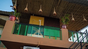 A multi-story building with a balcony, air conditioning units, and a staircase. - Pushkar Desert View (Pushkar)