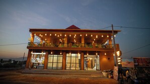 A two-story building with a balcony and multiple windows. - Pushkar Desert View (Pushkar)