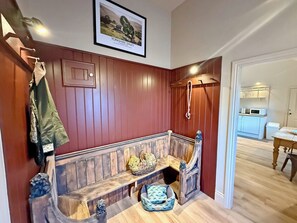 A wooden bench with a basket and a pet bed, a coat rack, and a framed picture on the wall. - Fern Tree Cottage - UK50962 (Kirklington near, Bedale)