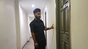 A person standing in a hallway with a door labeled '307'. - Motel Rajadani Residency (Hyderabad)