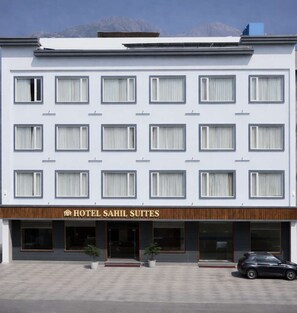 A hotel with a modern facade, multiple windows, and a sign reading "HOTEL SAHIL SUITES". - Hotel Sahil Suites (Katra)