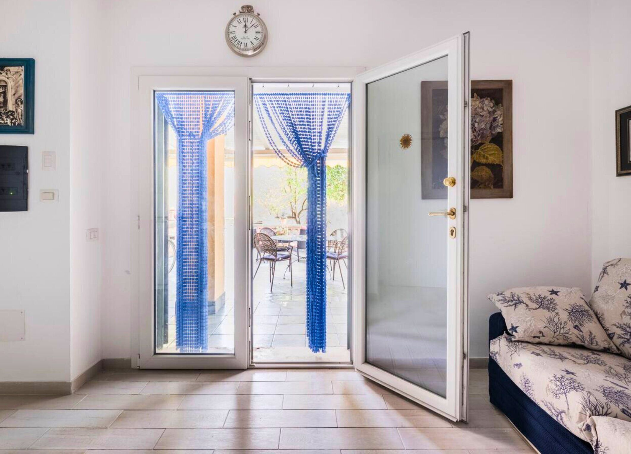 A room with a sliding glass door leading to an outdoor patio area.