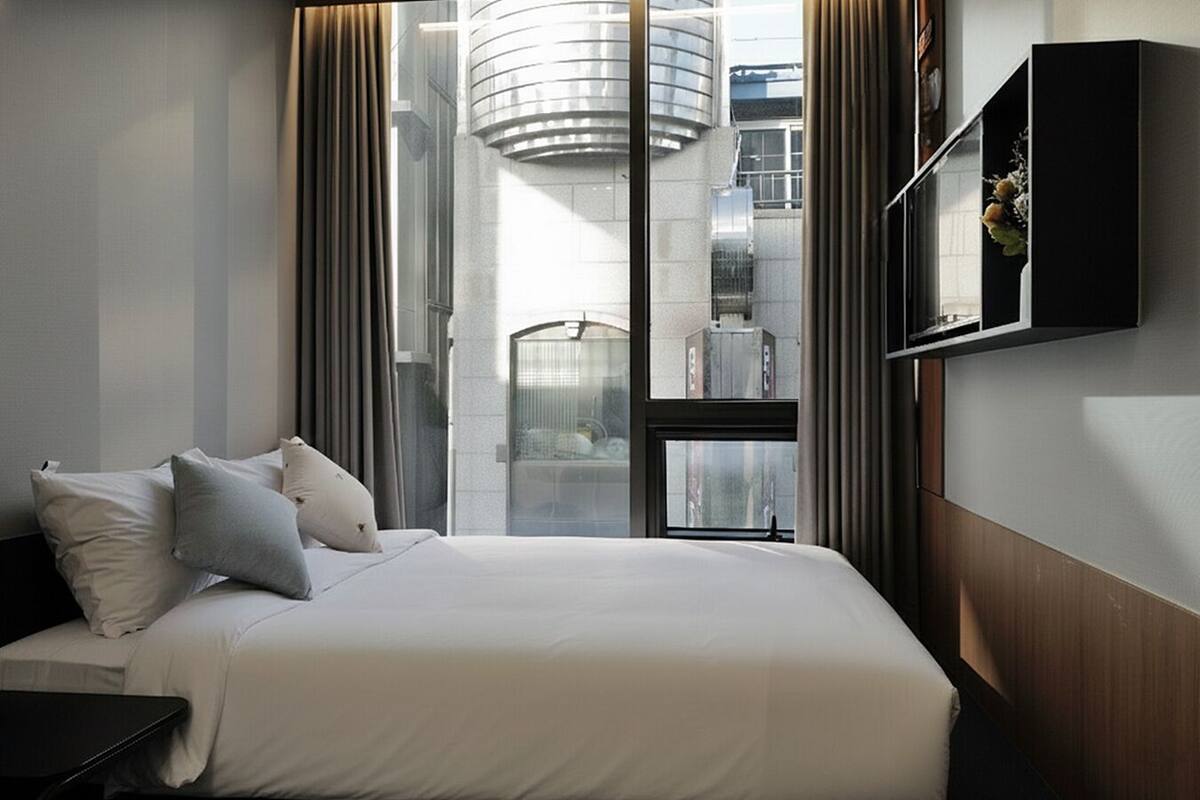 Double Room, City View | Blackout drapes, iron/ironing board, free WiFi