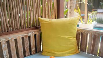 Deluxe Triple Room, 1 King Bed, Non Smoking, Pool View | Living area | Books