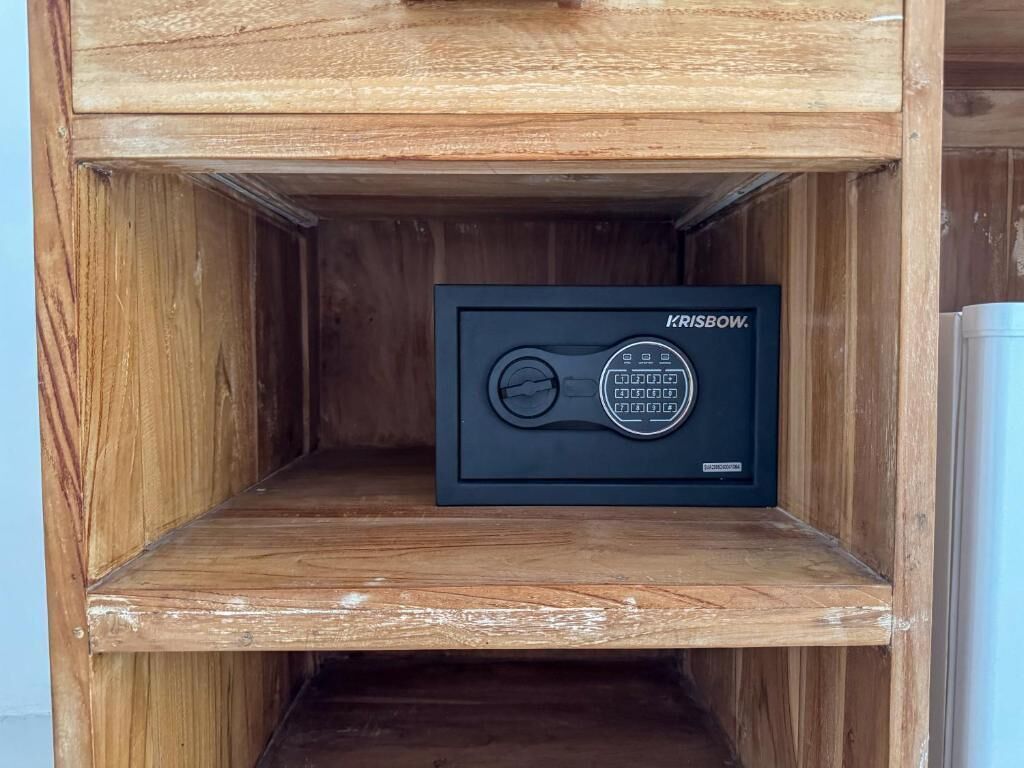 A wooden cabinet with a black box labeled "KRISBOW" inside.