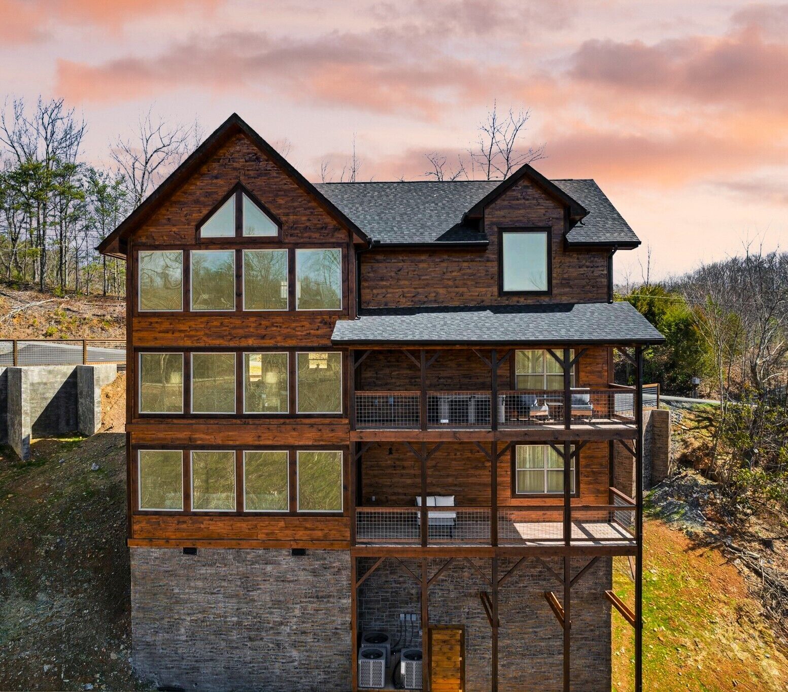 Stunning multi-level modern mountain cabin at sunset.