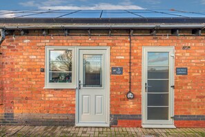 A brick building with two doors, one labeled '3 Billiards Room' and the other 'Electrical Cupboard.' - Pools Cottage 3 Billards Room-Games & Sports Court (Warwickshire)