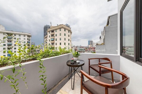 Family Room, City View | Outdoor dining - 22Land Classic Suites (Cau Giay)