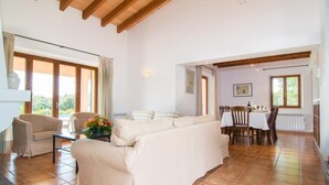 A spacious living area with a sofa, a dining table set for four, and a kitchen in the background. - Nice home in Arta with private swimming pool, can be inside or outside (Arta)