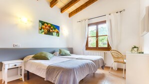A bedroom with a bed, two nightstands, a chair, a window with curtains, and a painting on the wall. - Awesome home in Arta with private swimming pool, can be inside or outside (Arta)