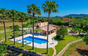 A villa with a swimming pool, surrounded by palm trees and a well-maintained lawn. - Awesome home in Arta with private swimming pool, can be inside or outside (Arta)