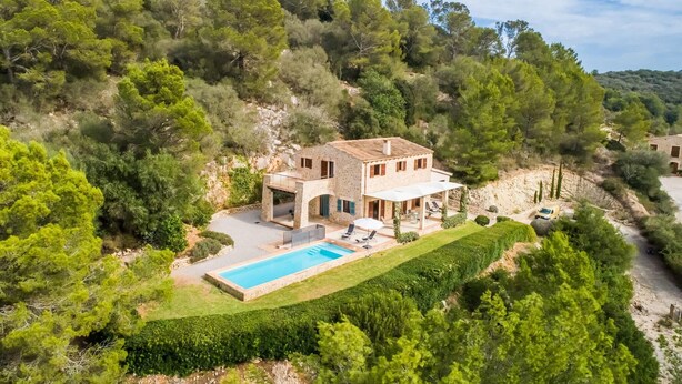 A two-story stone house with a swimming pool, surrounded by lush greenery and hills. - Luxurious home in Manacor with private swimming pool, can be inside or outside (Manacor)