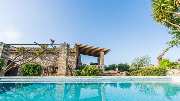 A pool with clear blue water, a stone building with a pergola, and lush greenery. - Lovely home in Arta with private swimming pool, can be inside or outside (Arta)