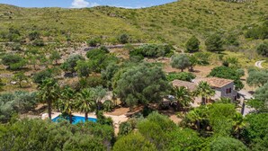 A villa with a pool surrounded by olive trees and a hilly landscape. - Nice home in Arta with private swimming pool, can be inside or outside (Arta)