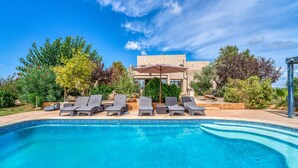 A swimming pool with lounge chairs and a stone building in the background. - Amazing home in Campos with private swimming pool, can be inside or outside (Campos)