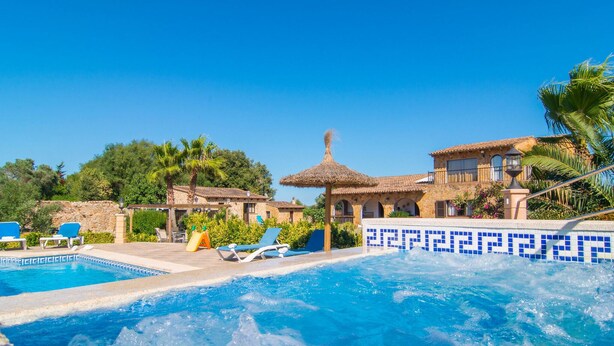 A pool area with lounge chairs, a hot tub, and a stone building with a tiled pool. - Lovely home in Arta with private swimming pool, can be inside or outside (Arta)