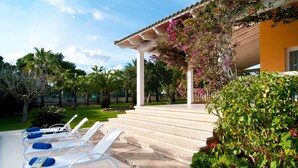 A covered outdoor area with lounge chairs and steps leading to a building. - Awesome home in Colonia de Sant Jordi (Colonia de Sant Jordi)
