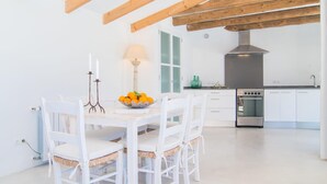 A modern kitchen with white cabinetry, a built-in oven, and a wooden ceiling. - Cozy home in Port Verd with private swimming pool, can be inside or outside (Port Verd)
