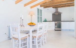 A modern kitchen with white cabinetry, a built-in oven, and a wooden ceiling. - Cozy home in Port Verd with private swimming pool, can be inside or outside (Port Verd)