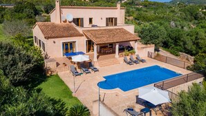 A two-story house with a swimming pool, outdoor furniture, and a view of the surrounding greenery and hills. - Awesome home in Alqueria Blanca (Alqueria Blanca)