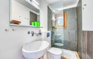 A modern bathroom with a large white bathtub, a separate toilet, a glass-enclosed shower, and a mirror above the sink. - Lovely home in Inca with private swimming pool, can be inside or outside (Inca)