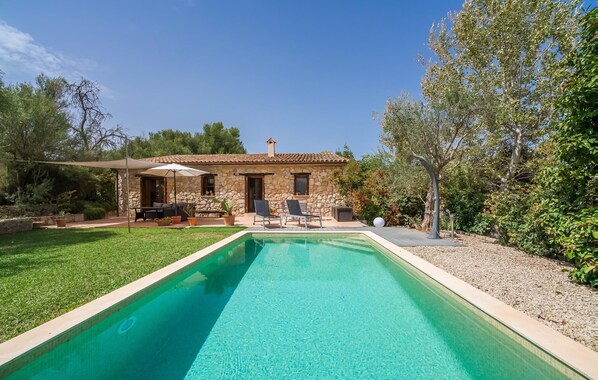 A stone house with a swimming pool, outdoor seating, and a garden. - Lovely home in Inca with private swimming pool, can be inside or outside (Inca)