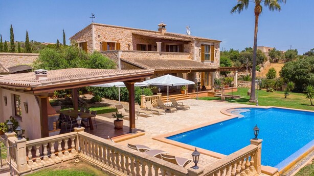 A stone villa with a swimming pool, outdoor seating, and a covered patio area. - Beautiful home in Cala Murada (Cala Murada)