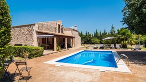 A poolside area with a stone building, lounge chairs, and a clear blue sky. - Lovely home in Buger with private swimming pool, can be inside or outside (Buger)