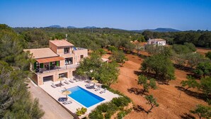 Eine moderne Villa mit Schwimmbad, mehreren Zimmern und Blick auf die umliegende Landschaft.