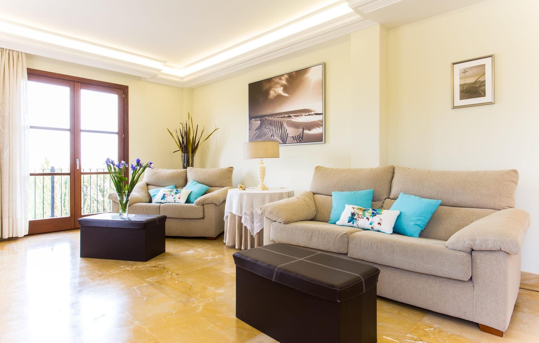 A living room with two sofas, a coffee table, a side table, and a painting on the wall.