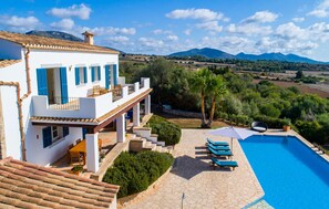 A villa with a pool, outdoor seating, and a view of the countryside. - Amazing home in Sant Llorenc (Sant Llorenc)