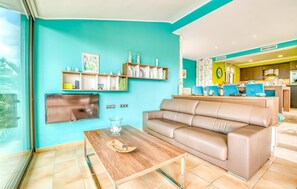 A living room with a sofa, coffee table, and shelves with books and decorative items. - Amazing home in Betlem with private swimming pool, can be inside or outside (Betlem)