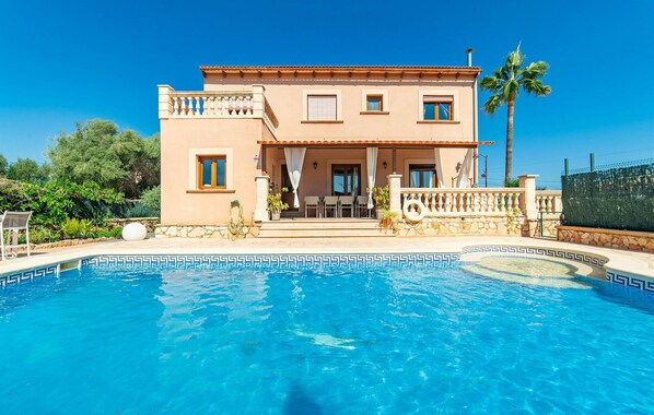 A two-story house with a swimming pool in front. - Amazing home in Portocolom with private swimming pool, can be inside or outside (Portocolom)