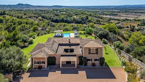 A large house with a swimming pool, surrounded by a well-maintained lawn and trees. - Awesome home in Son Macia with private swimming pool, can be inside or outside (Son Macia)