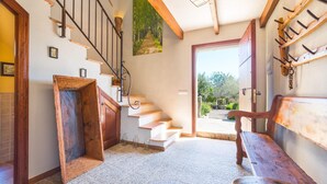 A rustic interior with a wooden staircase, a bench, and a view of the outdoors. - Luxurious home in Moscari with private swimming pool, can be inside or outside (Moscari)