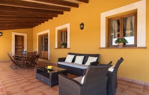 A patio with a sofa, chairs, and a table. - Gorgeous home in Pollenca with private swimming pool, can be inside or outside (Pollenca)