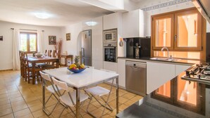 A modern kitchen with a dining area, featuring a refrigerator, oven, microwave, and dishwasher. - Stunning home in Felanitx with private swimming pool, can be inside or outside (Felanitx)