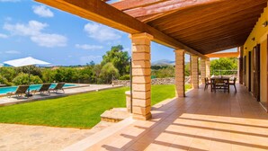 A covered outdoor patio with a pool, lounge chairs, and a dining area. - Lovely home in Arta with private swimming pool, can be inside or outside (Arta)