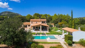A large house with a swimming pool, surrounded by lush greenery and hills. - Nice home in Pollenca with private swimming pool, can be inside or outside (Pollenca)