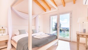 A bedroom with a four-poster bed, a large window, and a view of the outdoors. - Nice home in Alqueria Blanca (Alqueria Blanca)