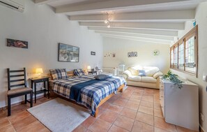 A cozy bedroom with a bed, a chair, a desk, and a small table. - Pet friendly home in Galilea (Galilea)