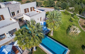 A modern villa with a swimming pool, multiple balconies, and lush landscaping. - Gorgeous home in Son Servera (Son Servera)