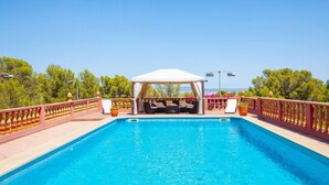 A swimming pool with a covered seating area and a view of the landscape. - La Casa de las Vistas (Palma)