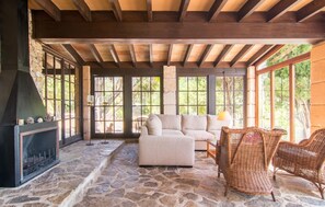 A stone-floored room with a fireplace, a sofa, and wicker chairs. - Pet friendly home in Arta with private swimming pool, can be inside or outside (Arta)