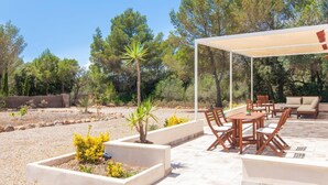 An outdoor patio with a table and chairs, surrounded by planters and a pergola. - Amazing home in Algaida with private swimming pool, can be inside or outside (Algaida)