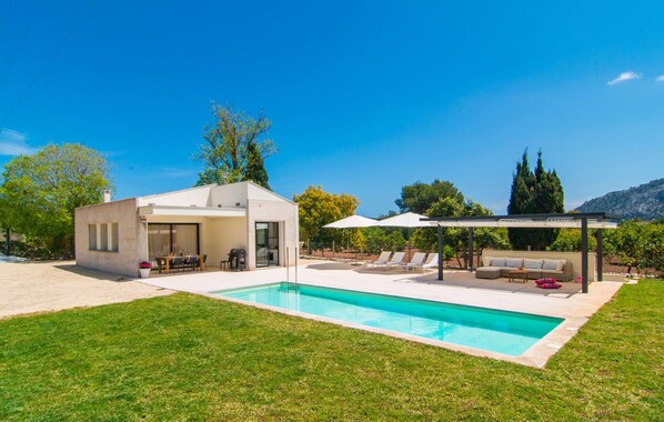 A modern house with a swimming pool, outdoor seating, and a covered patio. - Amazing home in Pollenca with private swimming pool, can be inside or outside (Pollenca)