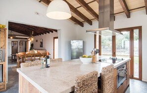 A spacious kitchen with a large island, wooden beams, and a view to the outdoors. - Awesome home in Arta with private swimming pool, can be inside or outside (Arta)