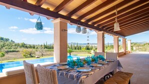 An outdoor dining area with a view of a pool and landscape. - Nice home in Arta with private swimming pool, can be inside or outside (Arta)