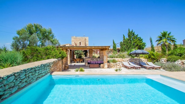A pool area with lounge chairs and a pergola. - Beautiful home in Es Trenc with private swimming pool, can be inside or outside (Es Trenc)